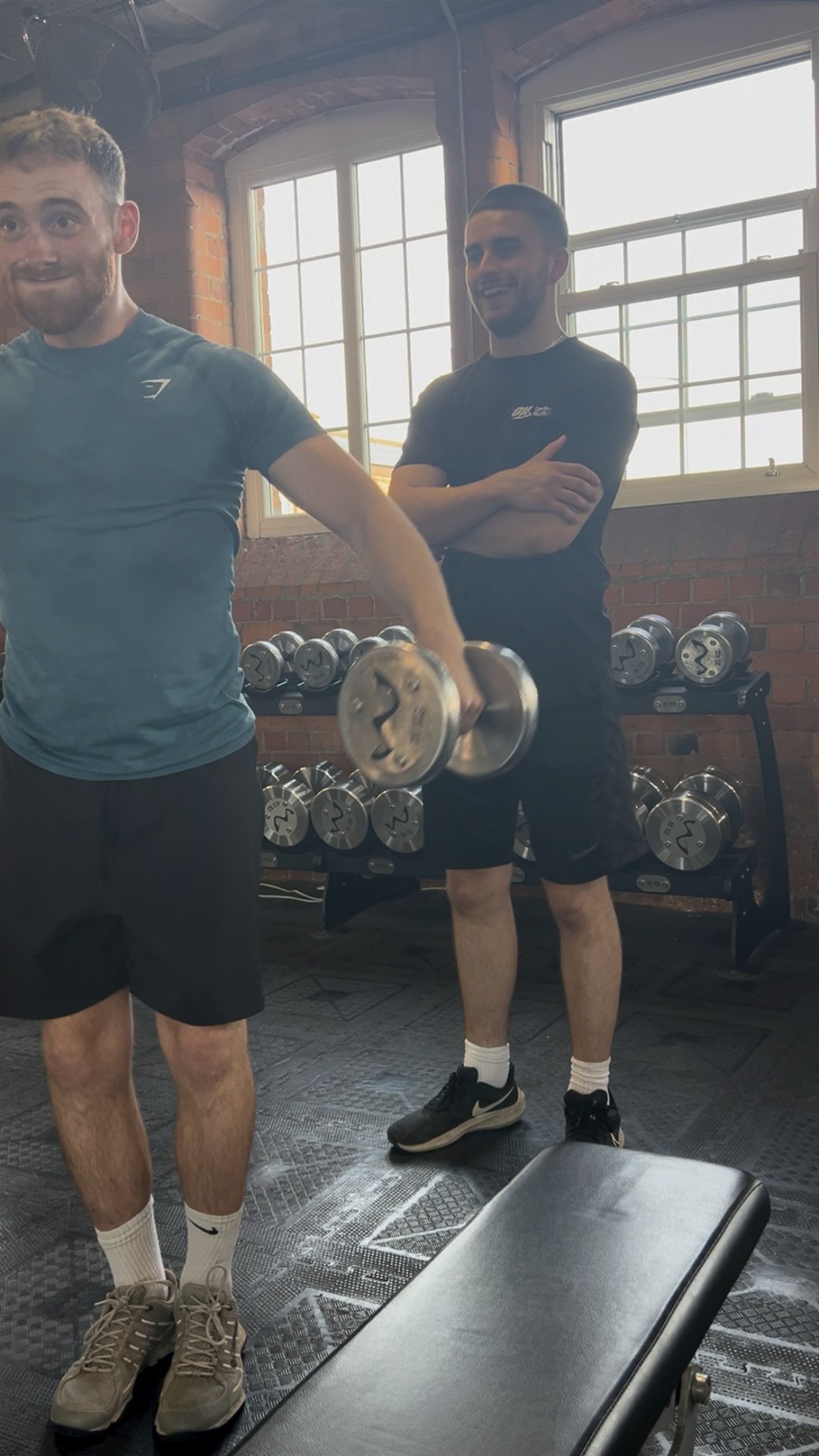 Alex coaching a client in the gym