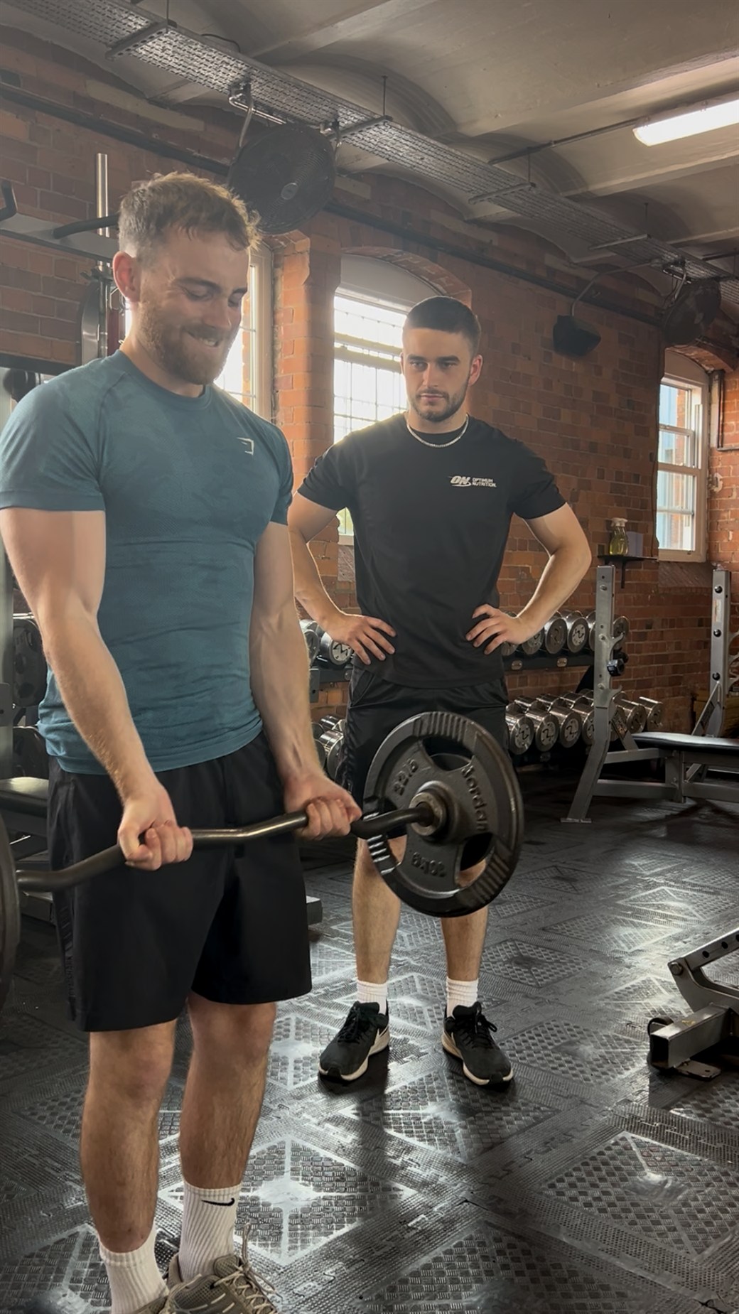 Alex coaching a barbell curl